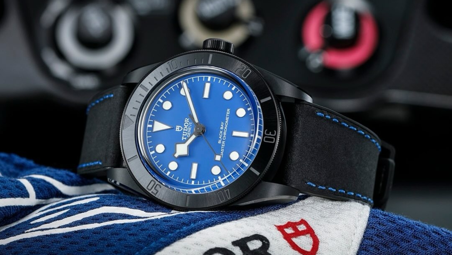 A close-up of a luxury sports watch inside of a car&rsquo;s dashboard.