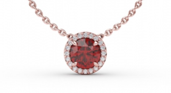 a rose gold pendant necklace featuring a round cut ruby surrounded by accent diamonds