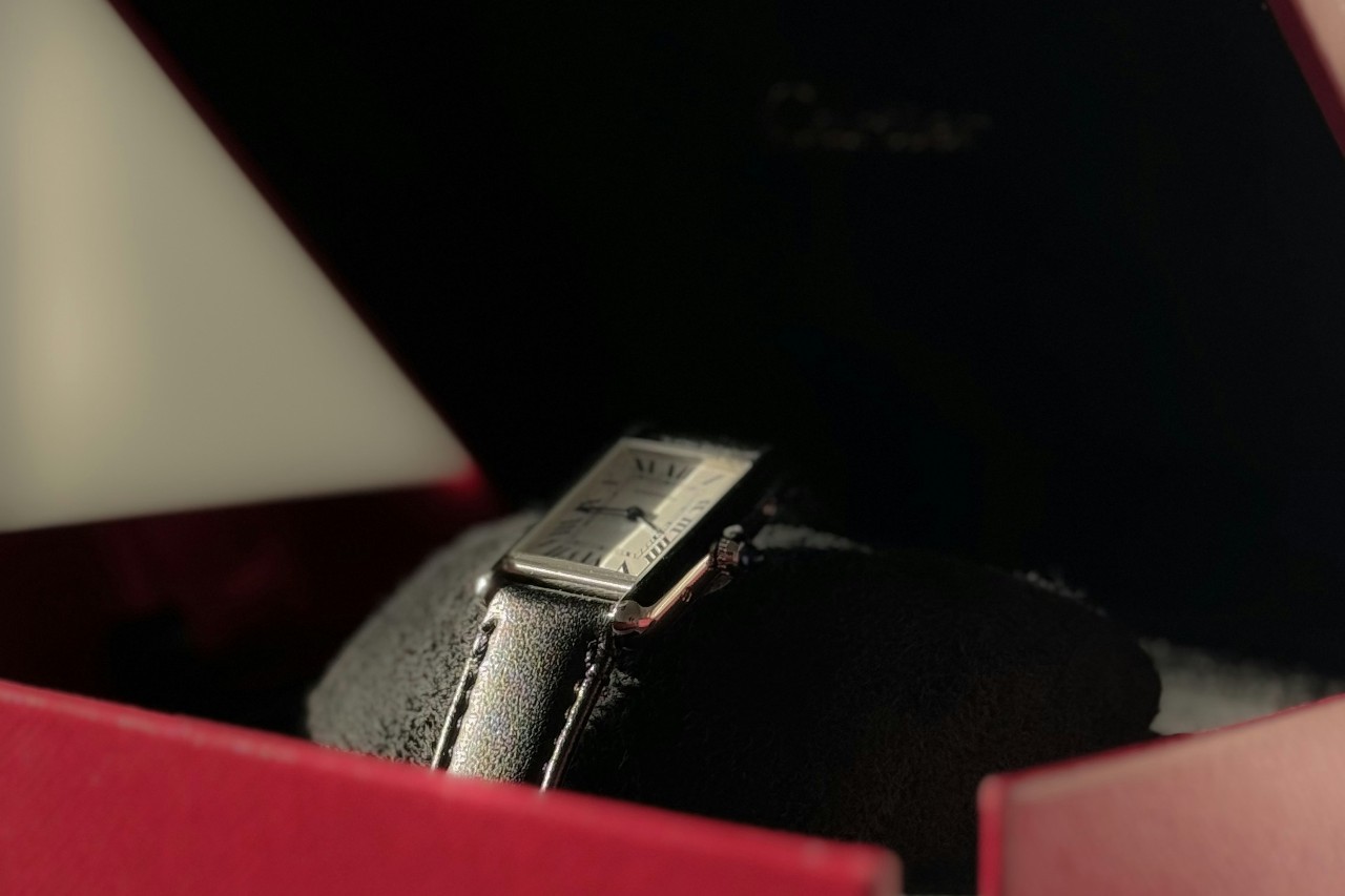 close up image of a Cartier Tank watch in a red box